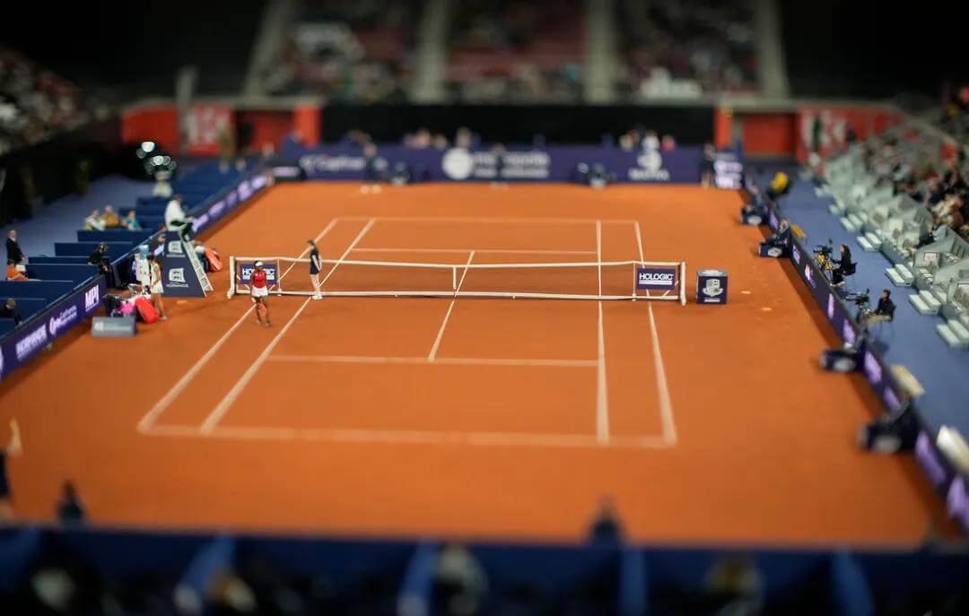 Red clay tennis court from aerial view